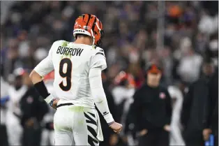  ?? TERRANCE WILLIAMS — THE ASSOCIATED PRESS FILE ?? Cincinnati Bengals quarterbac­k Joe Burrow flexes his right hand after an apparent injury suffered during the first half Thursday night against the Baltimore Ravens.