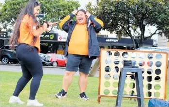  ?? Photo / Judith Lacy ?? City ambassador­s Aareta Mohi (left) and Janice Fai get their groove and laugh on in Te Marae o Hine — The Square.