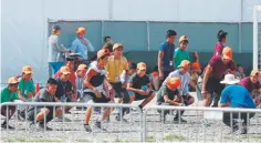  ?? Wilfredo Lee, Associated Press file ?? Migrant children exercise outside a temporary shelter in Homestead, Fla. in May. Because of cost overruns education and recreation­al programs were stopped last week.