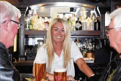  ??  ?? FRIENDLY Donna Lochhead pours the pints for regulars at The Anchor in Broughty Ferry