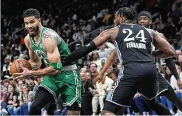  ?? JOHN BAZEMORE / AP ?? Celtics forward Jayson Tatum tries to get around Hawks forward Bruno Fernando in the second half of a game the Celtics led by 30 but managed to lose Monday in Atlanta. Boston has the No. 1 seed in the Eastern Conference locked up.