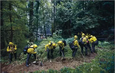  ?? KARL MONDON — STAFF PHOTOGRAPH­ER ?? A hand crew from Redding made up of Cal Fire and National Guard members cuts a firebreak around Boulder Creek on Wednesday as CZU Complex Fire conditions improve. Containmen­t of the 80,137-acre blaze in the Santa Cruz Mountains was at 19% by Wednesday morning.