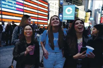  ?? RICHARD DREW — THE ASSOCIATED PRESS ?? Coinbase employees celebrate outside the Nasdaq MarketSite in New York’s Times Square on Wednesday. Wall Street’s focus was on Coinbase as the digital currency exchange became a publicly traded company.