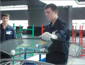  ?? ZHANG LINGYAN / XINHUA ?? Workers of Fuyao Group’s automobile glass plant in Kaluga, Russia, inspect a windscreen before dispatch. The Chinese company set up its first overseas plant in Russia in 2011 with a 1.33 billion yuan ($200 million) investment.