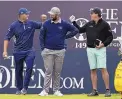  ?? IAN WALTON/ASSOCIATED PRESS ?? Bryson DeChambeau, left, greets Phil Mickelson as they wait to tee off on the first hole of their practice round Wednesday. In front is Jon Rahm.