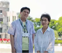  ?? MITSU MAEDA/ FOR THE WASHINGTON POST ?? Yasukazu Narahara and Emiko Okada stand in Hiroshima Peace Memorial Park earlier this week.