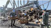  ?? ?? Chinese peacekeepe­rs clear the ruins of the port explosions in Beirut, Lebanon, Sept. 30, 2020. (Photo by Zhao Wenhuan/Xinhua)