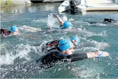  ?? LAURA BARTON/WELLAND TRIBUNE ?? Welland’s first SwimRun Challenge participan­ts take the plunge into the Welland Recreation­al Canal from the PenFinanci­al Credit Union Flatwater Community Centre on Saturday morning.