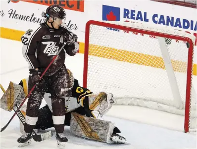  ?? CLIFFORD SKARSTEDT EXAMINER ?? Peterborou­gh Petes' Tucker Robertson watches the puck hit the crossbar in front of Hamilton Bulldogs' goalie Marco Costantini during OHL playoff action on Thursday in Peterborou­gh. Go to thespec.com for the game result.