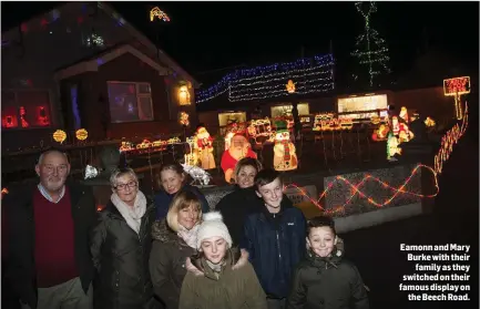  ??  ?? Eamonn and Mary Burke with their family as they switched on their famous display on the Beech Road.