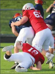  ?? ?? Shelby’s Xander Wilkins, top, and Plymouth’s Shawn English bring down a South player. (Photo by Nick Woodlock)