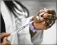  ?? GRAHAM / STAFF NICK ?? Kroger nurse practition­er Amanda Flowers prepares vaccines to be administer­ed to school staff Feb. 3 at Lakota West High School in West Chester Township.