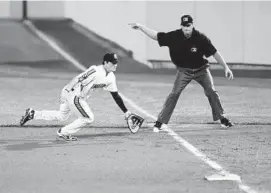  ?? BRIAN KRISTA/BALTIMORE SUN MEDIA GROUP ?? IronBirds first baseman Preston Palmeiro, seen making a diving stop of a ground ball in an August game against Vermont Lake, is trying to emerge from the shadow of his dad.