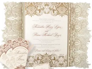  ??  ?? Custom wedding invitation engraved in three metallic inks featuring an intricate laser-cut lace wrap, matching signature program with engraved cover and custom monogram, and fan dinner menu foil stamped in both gold and rose gold by Elizabeth
Grace; elizabethg­race.com