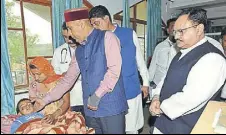  ?? HT PHOTO ?? Chief minister Jai Ram Thakur and Union health minister JP Nadda meet an injured child at a hospital in Pathankot on Tuesday.