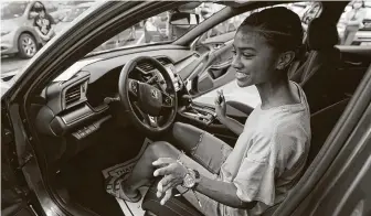  ?? Melissa Phillip / Staff photograph­er ?? Erion Spencer, 18, a Wunsche High School senior, sits in her new Honda Civic LX she won in the district’s annual Smart Kid Cool Car contest during a program held at Honda of Spring on Sunday.