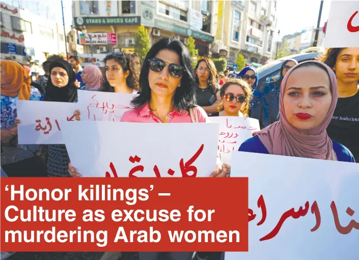  ?? (Mohamad Torokman/Reuters) ?? A DEMONSTRAT­OR holds a banner demanding legal protection for women, in Ramallah on September 4.