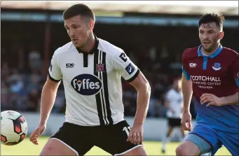  ??  ?? Killian Brennan tries to keep tabs on Dundalk’s Patrick McEleney.