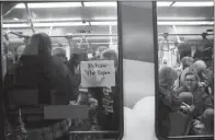  ?? AP/LEILA NAVIDI ?? Protesters get on a train Wednesday at the Mall of America in Minneapoli­s to travel to Minneapoli­s-St. Paul Internatio­nal Airport where a Black Lives Matter rally had moved.