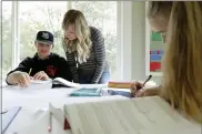  ?? ASSOCIATED PRESS FILE PHOTO ?? Donya Grant, center, works on a homeschool lesson with her son Kemper, 14, as her daughter Rowyn, 11, works at right, at their home in Monroe, Wash.