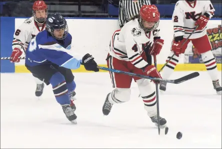  ?? Dave Stewart / Hearst Connecticu­t Media ?? New Canaan’s Kaleigh Harden skates with the puck while under pressure from ETB’s Madison Archambaul­t during the CHSGHA semifinals in Shelton on March 5.