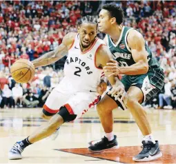  ??  ?? Toronto Raptors forward Kawhi Leonard (left) drives to the net around Milwaukee Bucks guard Malcolm Brogdon during the second overtime period of Game 3 of the NBA basketball playoffs Eastern Conference finals in Toronto. (AP)