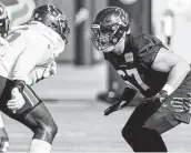  ?? Brett Coomer / Staff photograph­er ?? Charlie Heck, right, drops back to block Vincent Taylor at practice Thursday. Heck seems prime to lock up a starting spot along the offensive line.