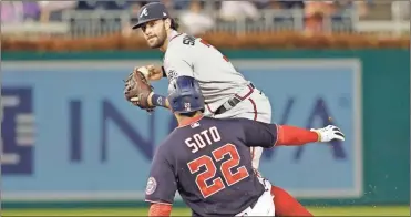  ?? Geoff Burke ?? Atlanta Braves shortstop Dansby Swanson (7) attempts to turn a double play ahead of a slide by Washington Nationals left fielder Juan Soto (22) in the fourth inning at Nationals Park.