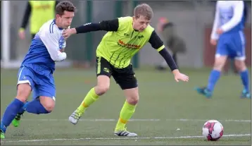  ??  ?? Philip Duffy, Muirhevnam­ór holds off his opponent Jason Hughes, Ballynanty Rovers.