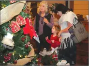  ?? NEWS-SENTINEL FILE PHOTOGRAPH ?? Maxine Hackwork admires one of the many trees with her granddaugh­ter Evelyn Balogh, 4, and daughter Wendy Balogh during the Festival of Trees at the San Joaquin County Historical Museum in Micke Grove Park.