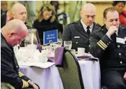  ?? [OKLAHOMAN ARCHIVES PHOTO] ?? Members of the Midwest City Fire Department bow their heads as a prayer is given during the 2014 Martin Luther King Jr. breakfast.