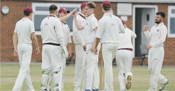  ??  ?? Eppleton bowler Jack McBeth gets congratula­ted after taking the wicket of Newcastle opener Oliver McGee at Church Road on Saturday. Pictures by Tim Richardson.