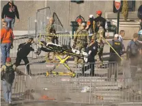  ?? CHARLIE RIEDEL/THE ASSOCIATED PRESS ?? Emergency crew at the scene of a shooting Wednesday after the Kansas City Chiefs’ Super Bowl parade in Kansas City, Mo.