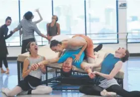  ??  ?? Dancers with the Colorado Ballet rehearse this month for the Oct. 6 premiere of “Dracula” in Denver. Performer Yosvani Ramos is on his back.