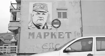  ??  ?? A mural of former Bosnian Serb general Ratko Mladic is seen on a building in Gacko, Bosnia and Herzegovin­a. — Reuters photo