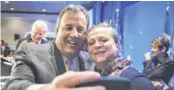  ?? CLIFF OWEN, AP ?? New Jersey Gov. Chris Christie takes a cellphone photo with NGA staffer Lily Kersh during the National Governors Associatio­n winter meeting Saturday.