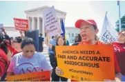  ?? J. SCOTT APPLEWHITE/ASSOCIATED PRESS ?? Activists demonstrat­e in front of the Supreme Court in Washington on Thursday as the justices finish the term with decisions on gerrymande­ring and the census.