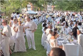  ??  ?? Hundreds of guests were transporte­d Aug. 4 to Dîner en Blanc’s secret location at Memphis Park via chartered buses. Attendees brought their own formal picnic wear and were required to dress in all white. BRANDON DILL / FOR COMMERCIAL APPEAL