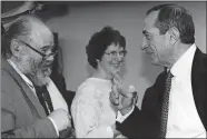  ?? AP PHOTO ?? This 1991 photo provided by his daughter Leah Pike, shows retired Associated Press reporter Rayner Pike, left, during an encounter with former New York Gov. Mario Cuomo.