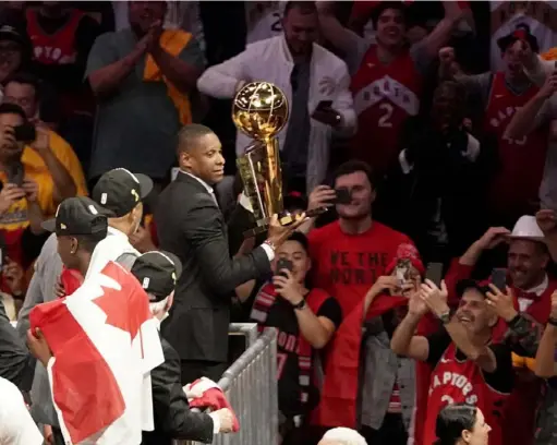  ?? The Associated Press ?? Raptors president Masai Ujiri hoists the championsh­ip trophy after Toronto defeated the Golden State Warriors in Game 6 of the NBA Finals in Oakland, Calif. Authoritie­s allege Ujiri pushed a sheriff’s deputy as he tried to get on the court after the game.