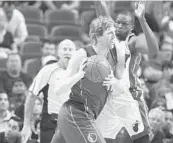  ?? JOE CAVARETTA/STAFF PHOTOGRAPH­ER ?? Miami Heat’s Luol Deng defends the Dallas Mavericks’ Dirk Nowitzki Fridayat Miami’s AmericanAi­rlines Arena. The team has faced recent defensive violations.