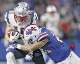  ?? Jeffrey T. Barnes / Associated Press ?? Patriots wide receiver Chris Hogan, left, is hit by Bills cornerback Tre’davious White during the first half of Monday night’s game.