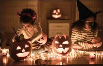  ??  ?? Whether you like fright or delight, there are a lot of ways you can get creative for Halloween on a budget. One is to make use of things you already have, or shop for inexpensiv­e items such as a strings of lights.