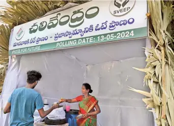  ?? V. RAJU ?? A banner put up at a water kiosk set up by the GVMC urges the voters to exercise their franchise during the elections, in Visakhapat­nam on Wednesday.