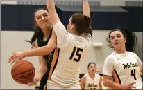  ?? ?? Lake Orions’ Izzy Wotlinski, left, tries to put up a shot over Clarkston’s Elia Morgner, No. 15, in a Division 1district championsh­ip game at Waterford Mott High School on Friday. The Wolves got a layup from Morgner with 1.4seconds left to beat the Dragons, 41-40.