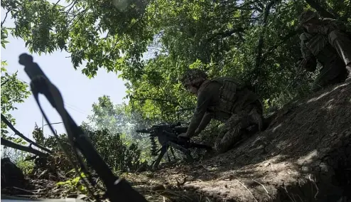  ?? ?? A Ukrainian marine of 35th brigade fires by automatic grenade launcher AGS-17 towards Russian positions on the outskirts of Avdiivka, Ukraine, on June 19, 2023.