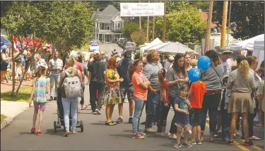  ?? Terrance Armstard/News-Times ?? Mayhaw jelly: People fill the streets of North Jackson Avenue while attending the 26th annual Mayhaw Festival on Saturday. The event included activities such as rock climbing, 10K and 5K Races, a Mayhaw breakfast with biscuits and live bluegrass music...