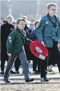  ?? 25_c46remembr­ance07 ?? Scouts approach the cenotaph.