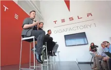  ?? RICH PEDRONCELL­I, AP ?? Tesla CEO Elon Musk, left, built a giant Gigafactor­y in Sparks, Nev., that makes batteries for the company’s electric cars.