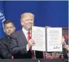  ?? SUSAN WALSH/ASSOCIATED PRESS ?? President Donald Trump holds up an executive order he signed during a visit to Kenosha, Wis.